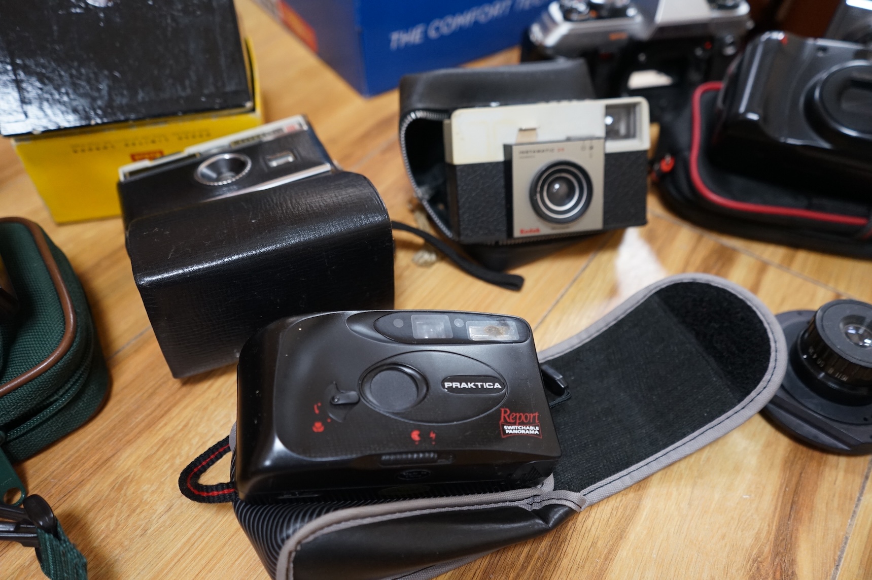 A collection of various cameras and camera equipment to include Konica